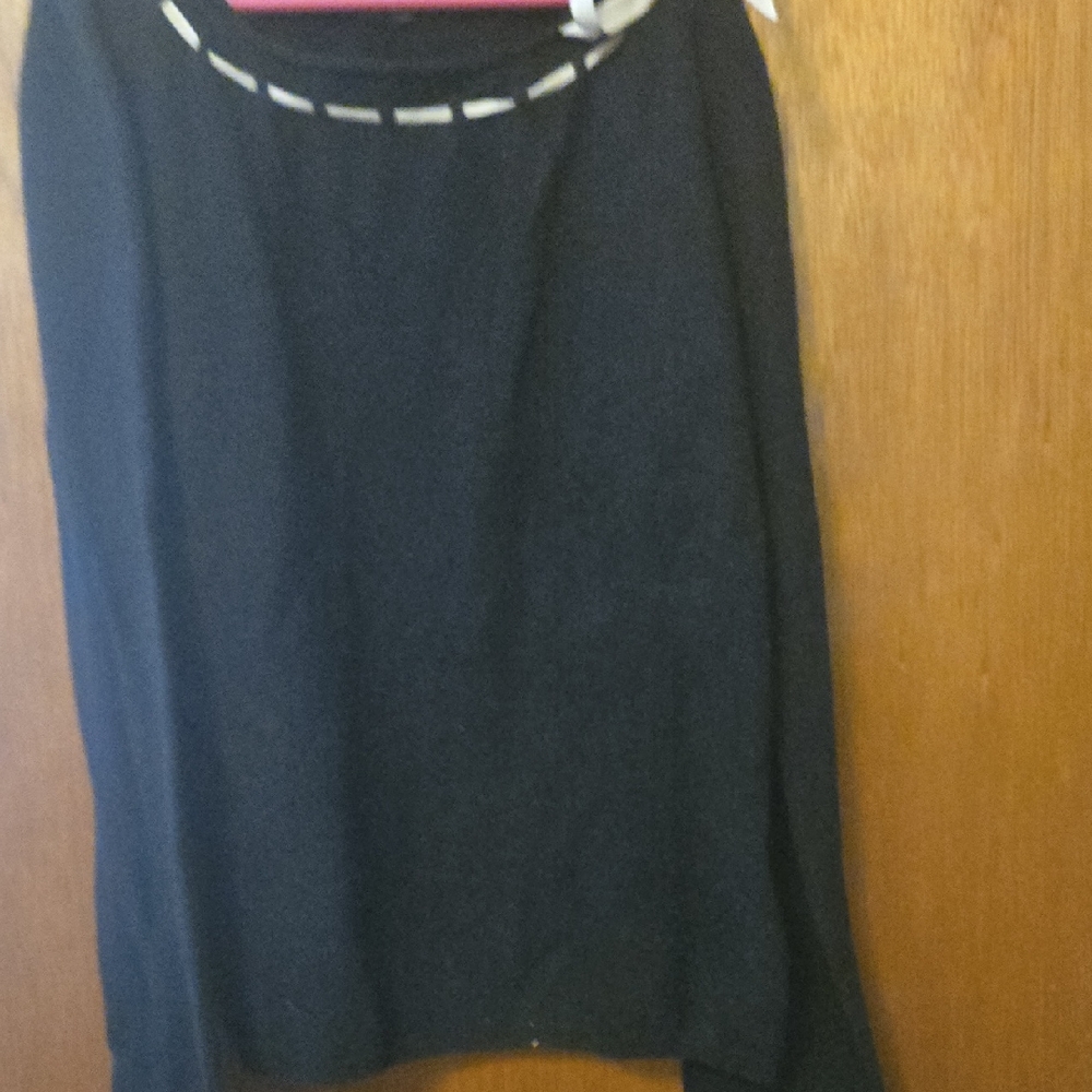 ECI Black sweater with pibk ribbon along neck line with delicate bow on left.